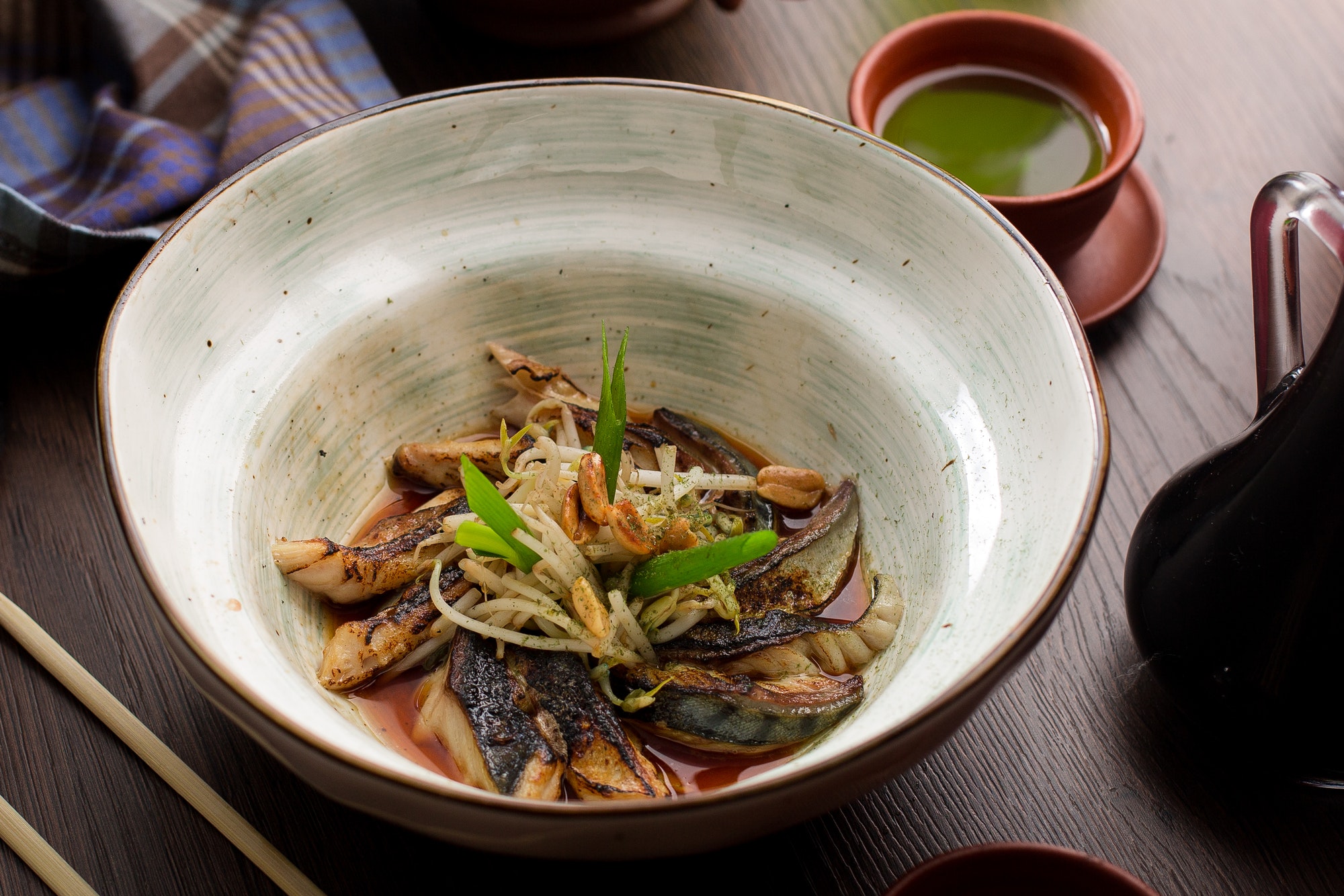 Asian food: fish with sprouts and peanuts in a restaurant